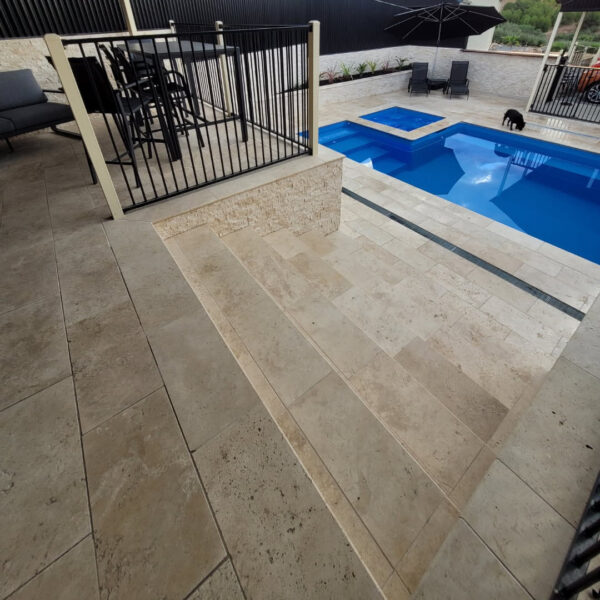 Classic Cream Travertine pool paving and Bookleaf Wall Cladding