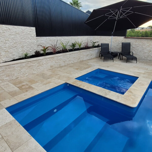 Classic Cream Travertine pool paving and Bookleaf Wall Cladding1