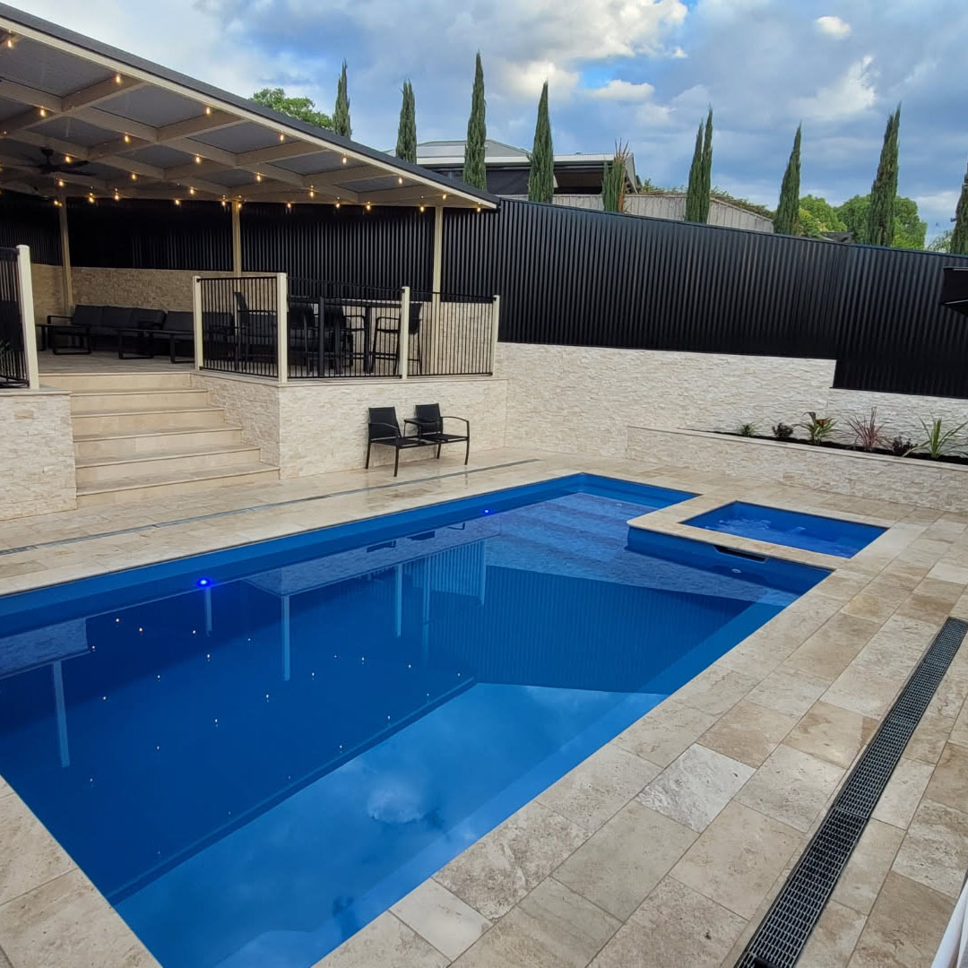 Classic Cream Travertine pool paving and Bookleaf Wall Cladding3