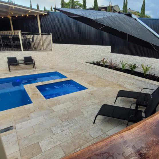 Classic Cream Travertine pool paving and Bookleaf Wall Cladding4