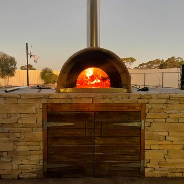 Lit Pizza Oven with wall cladding | MO Rustic Creations