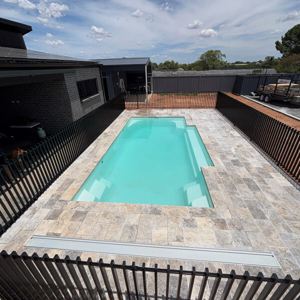 Silver Travertine with drop face Pool Paving | MTK Carpentry Construction.jpeg